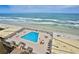 Ocean view rooftop pool with lounge chairs at 4139 Atlantic # A406, New Smyrna Beach, FL 32169