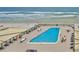 Ocean view rooftop pool with lounge chairs at 4139 Atlantic # A406, New Smyrna Beach, FL 32169
