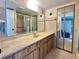 Bathroom with double sinks, large mirror, and tiled floor at 4150 S Atlantic Ave # 103A, New Smyrna Beach, FL 32169