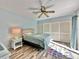 Bedroom with queen bed, ceiling fan and sliding door to balcony at 4150 S Atlantic Ave # 103A, New Smyrna Beach, FL 32169