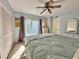 Bedroom with a queen-size bed, dresser, and access to balcony at 4150 S Atlantic Ave # 103A, New Smyrna Beach, FL 32169