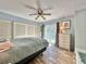 Bedroom with queen bed, ceiling fan and sliding door to balcony at 4150 S Atlantic Ave # 103A, New Smyrna Beach, FL 32169