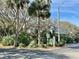 Building entrance with lush landscaping and visible address numbers at 4150 S Atlantic Ave # 103A, New Smyrna Beach, FL 32169