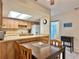 Kitchen features wood cabinets, breakfast bar, and access to a sunroom at 4150 S Atlantic Ave # 103A, New Smyrna Beach, FL 32169