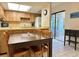 Bright kitchen with wood cabinets, tiled floors, and a breakfast bar at 4150 S Atlantic Ave # 103A, New Smyrna Beach, FL 32169