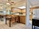 Kitchen boasts wood cabinets, tiled floors and a view into the dining area at 4150 S Atlantic Ave # 103A, New Smyrna Beach, FL 32169