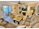 Spacious living room featuring a fireplace and access to a patio at 4150 S Atlantic Ave # 103A, New Smyrna Beach, FL 32169