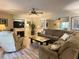 Comfortable living room features a large sectional sofa and wood floors at 4150 S Atlantic Ave # 103A, New Smyrna Beach, FL 32169