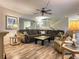 Open living room with wood floors, sectional sofa, and fireplace at 4150 S Atlantic Ave # 103A, New Smyrna Beach, FL 32169