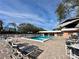 Inviting community pool with lounge chairs and patio tables at 4150 S Atlantic Ave # 103A, New Smyrna Beach, FL 32169