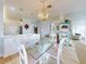 Bright dining area with glass-top table and chandelier at 438 Bouchelle Dr # 104, New Smyrna Beach, FL 32169