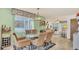 Dining room with glass-top table and wicker chairs, overlooking living room at 4411 Sea Mist Ct # 275, New Smyrna Beach, FL 32169