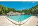Inviting community pool with lounge chairs and a pool house at 4411 Sea Mist Ct # 275, New Smyrna Beach, FL 32169