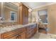 Double vanity bathroom with granite countertops and large mirror at 460 Bouchelle Dr # 305, New Smyrna Beach, FL 32169