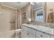 Updated bathroom with granite countertop, shower, and bathtub at 460 Bouchelle Dr # 305, New Smyrna Beach, FL 32169