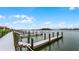 White wooden boardwalk with multiple boat docks and water access at 460 Bouchelle Dr # 305, New Smyrna Beach, FL 32169