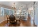 Charming dining area with hardwood floors and a view into the kitchen at 460 Bouchelle Dr # 305, New Smyrna Beach, FL 32169