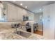 Updated kitchen features granite countertops, stainless steel appliances, and ample cabinetry at 460 Bouchelle Dr # 305, New Smyrna Beach, FL 32169