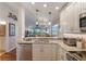 Modern kitchen with granite countertops and stainless steel appliances at 460 Bouchelle Dr # 305, New Smyrna Beach, FL 32169