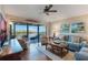 Spacious living room with water views, hardwood floors, and comfortable seating at 460 Bouchelle Dr # 305, New Smyrna Beach, FL 32169