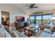 Spacious living room with water views and access to balcony at 460 Bouchelle Dr # 305, New Smyrna Beach, FL 32169