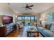 Relaxing living room with water views, hardwood floors, and comfortable seating at 460 Bouchelle Dr # 305, New Smyrna Beach, FL 32169