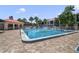 Refreshing community pool area with surrounding patio at 460 Bouchelle Dr # 305, New Smyrna Beach, FL 32169