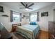 Bright bedroom with wood floors and ceiling fan at 4623 Saxon Dr, New Smyrna Beach, FL 32169