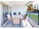 Private balcony with table and chairs, perfect for outdoor dining at 5300 S Atlantic Ave # 1-203, New Smyrna Beach, FL 32169