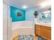 Bathroom featuring a corner soaking tub and walk-in shower at 5300 S Atlantic Ave # 1-203, New Smyrna Beach, FL 32169