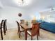 Bright dining room with wooden table and seating for four at 5300 S Atlantic Ave # 1-203, New Smyrna Beach, FL 32169