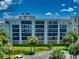 Condo building exterior with palm trees and parking lot at 5300 S Atlantic Ave # 1-203, New Smyrna Beach, FL 32169