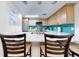 Modern kitchen features light wood cabinets and a breakfast bar at 5300 S Atlantic Ave # 1-203, New Smyrna Beach, FL 32169