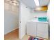 Laundry room with washer, dryer, and storage shelves at 5300 S Atlantic Ave # 1-203, New Smyrna Beach, FL 32169
