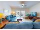 Spacious living room with comfortable seating and a large TV at 5300 S Atlantic Ave # 1-203, New Smyrna Beach, FL 32169