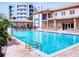 Community swimming pool with plenty of lounge chairs at 5300 S Atlantic Ave # 1-203, New Smyrna Beach, FL 32169