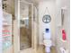 Bathroom with a walk-in shower, toilet, and decorative accents at 5300 S Atlantic Ave # 17-506, New Smyrna Beach, FL 32169