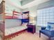 Cozy bedroom with bunk beds and sitting area at 5300 S Atlantic Ave # 17-506, New Smyrna Beach, FL 32169