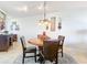 Bright dining room with round wooden table and four leather chairs at 5300 S Atlantic Ave # 17-506, New Smyrna Beach, FL 32169