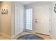 Bright entryway with tile flooring, coat closet, and glass block window at 5300 S Atlantic Ave # 17-506, New Smyrna Beach, FL 32169