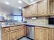 Kitchen with granite countertops, stainless steel dishwasher, and wood cabinets at 5300 S Atlantic Ave # 17-506, New Smyrna Beach, FL 32169