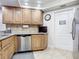 Kitchen with granite countertops, stainless steel dishwasher, and wood cabinets at 5300 S Atlantic Ave # 17-506, New Smyrna Beach, FL 32169