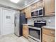 Kitchen features stainless steel appliances and wood cabinets at 5300 S Atlantic Ave # 17-506, New Smyrna Beach, FL 32169