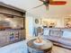 Spacious living room with large TV, comfy couch, and ceiling fan at 5300 S Atlantic Ave # 17-506, New Smyrna Beach, FL 32169