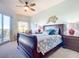 Bright bedroom with a sleigh bed and access to balcony at 5300 S Atlantic Ave # 17-506, New Smyrna Beach, FL 32169