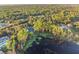 Aerial view showcasing home, lake, and surrounding landscape at 535 Valley Stream Dr, Geneva, FL 32732