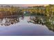 House nestled on a lake with lush green trees surrounding it at 535 Valley Stream Dr, Geneva, FL 32732