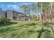 Spacious backyard with screened enclosure, lush lawn, and mature trees at 535 Valley Stream Dr, Geneva, FL 32732