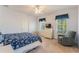 Bedroom with a full bed, sitting chair, and a TV at 535 Valley Stream Dr, Geneva, FL 32732