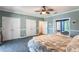 Spacious bedroom with carpet, ceiling fan, and ample closet space at 535 Valley Stream Dr, Geneva, FL 32732